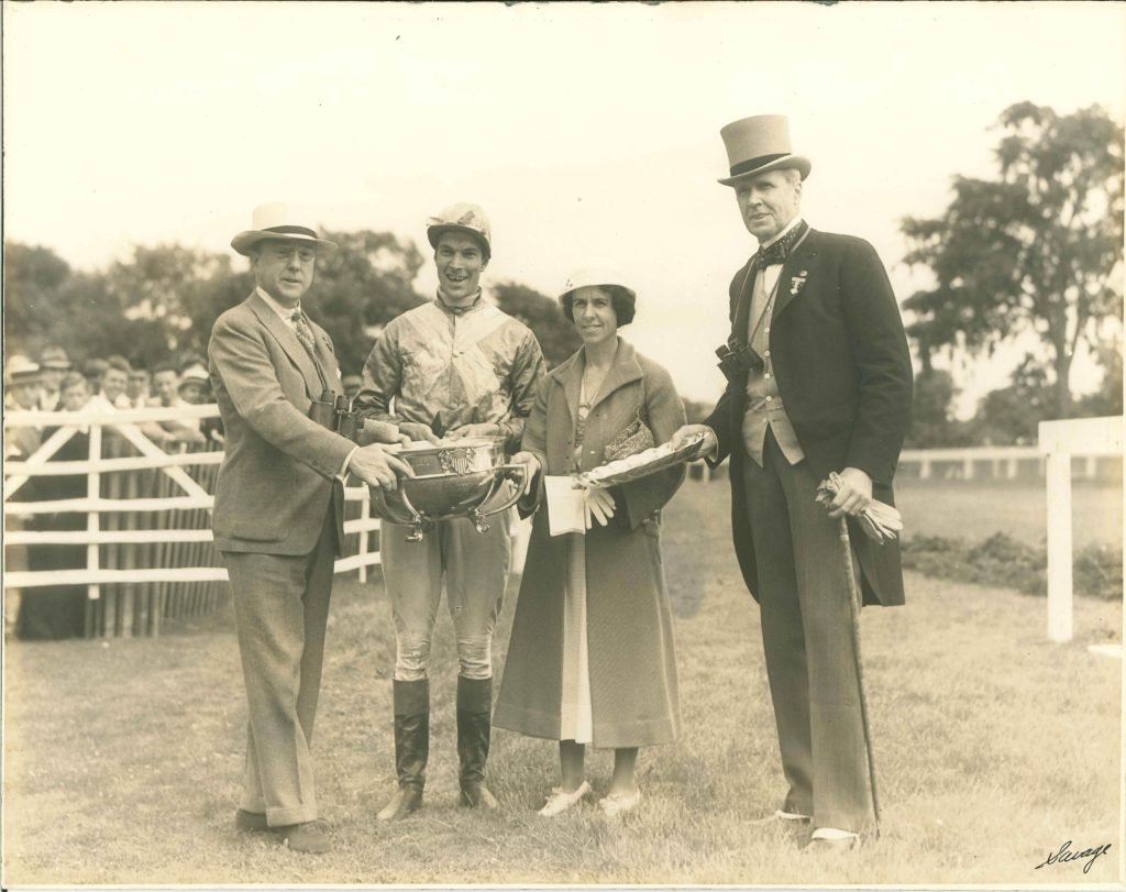   Mrs. Scott and her jockey and friend, Carol Bassett, accept a trophy, 1930’s.  